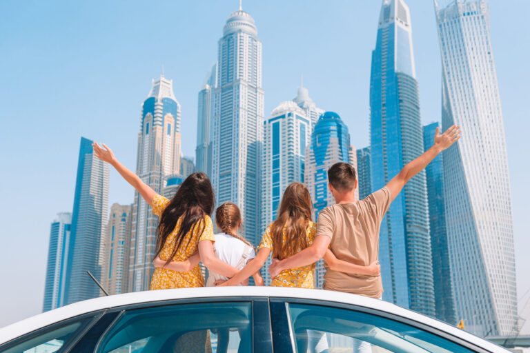 Family,Of,Four,On,Car,Vacation,On,Background,Of,Skyscrapers